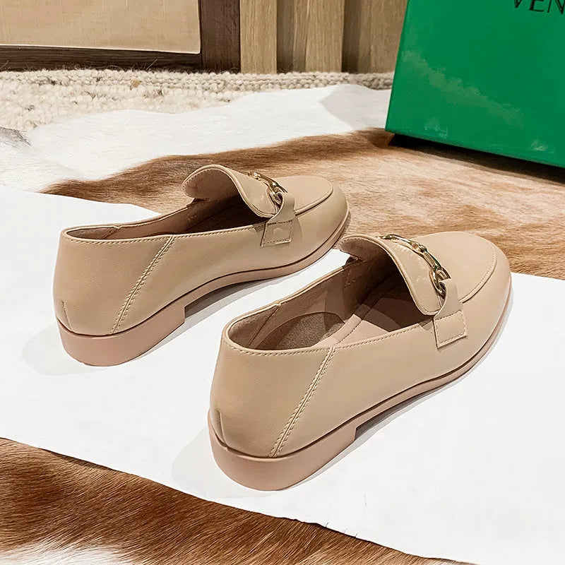 Women's black leather flat shoes with round toe and low heel, side view