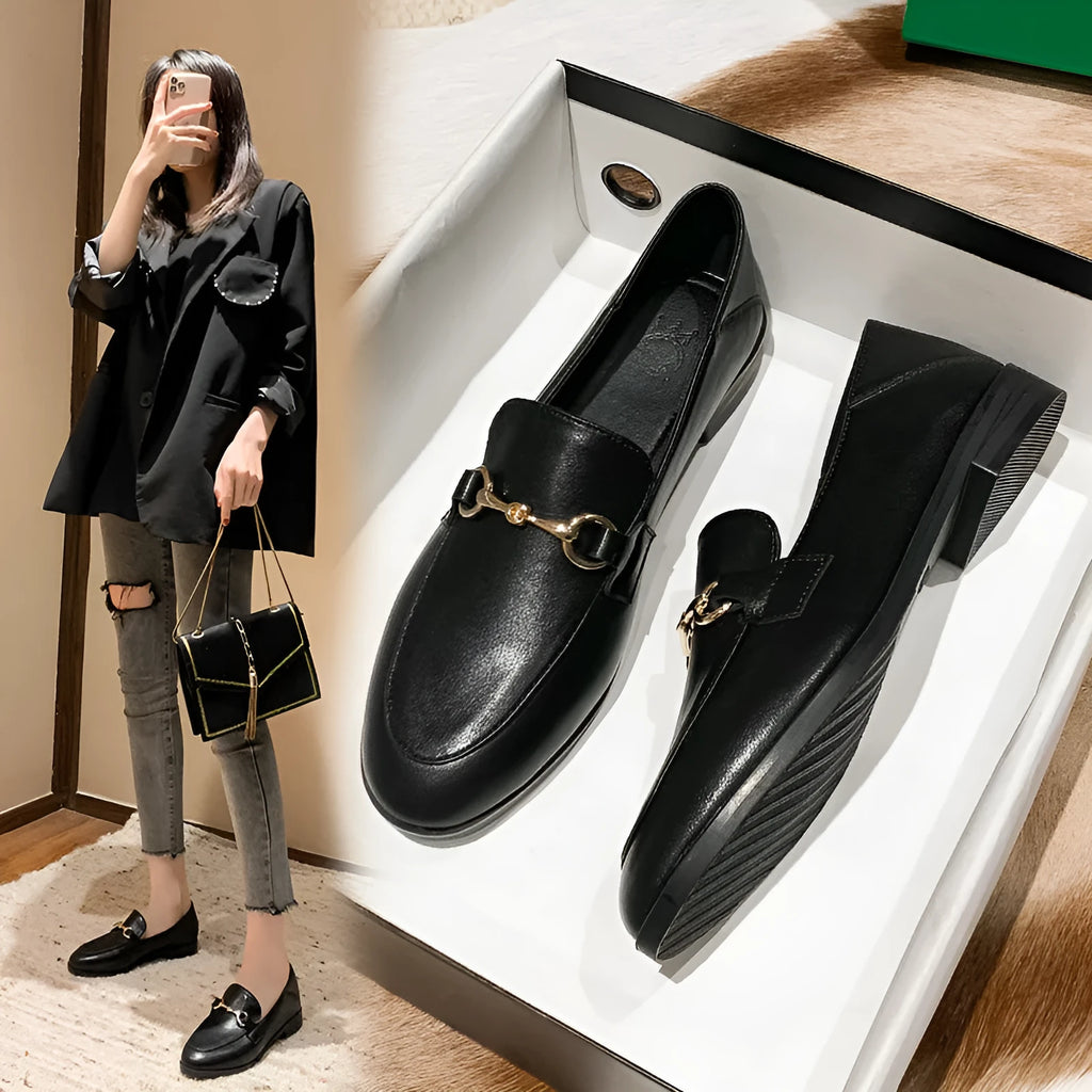 Women's black leather flat shoes with round toe and low heel, side view