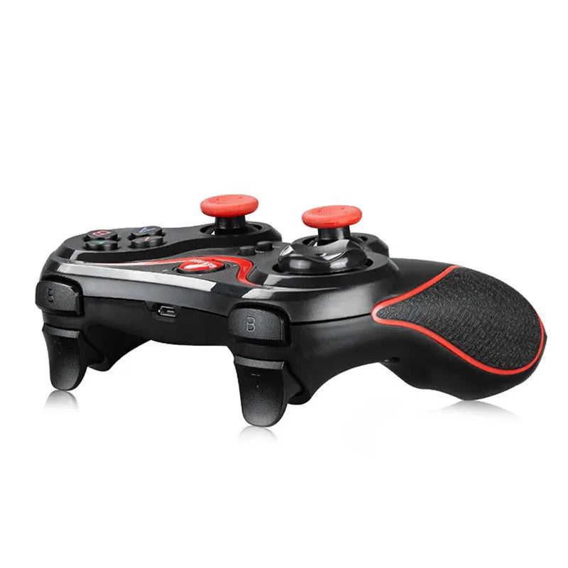 Black wireless Bluetooth mobile game controller with charging cable on a table.