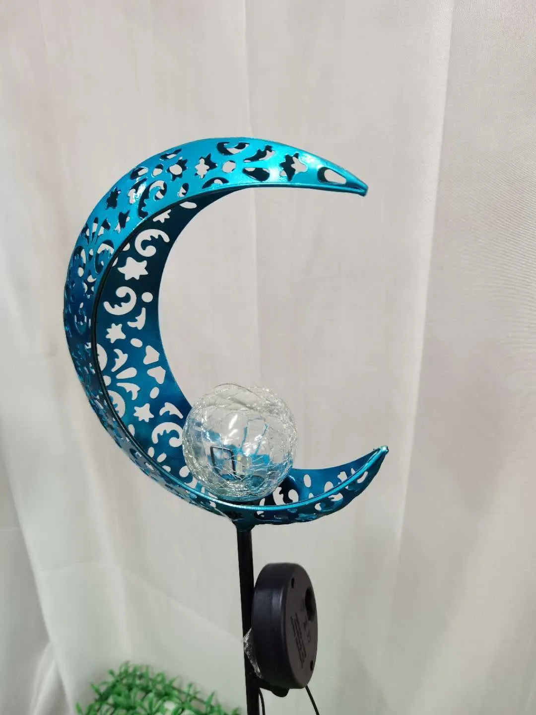 Solar-powered blue moon garden light with wrought iron frame and glass ball
