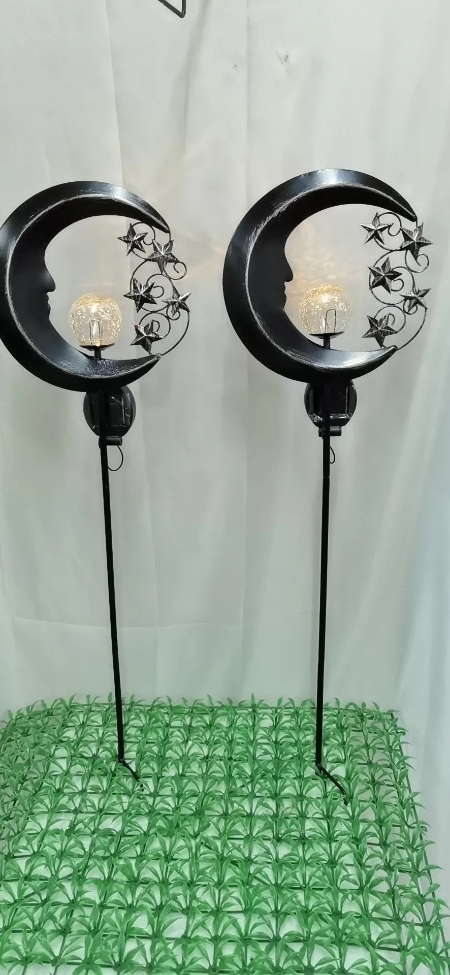 Solar-powered blue moon garden light with wrought iron frame and glass ball