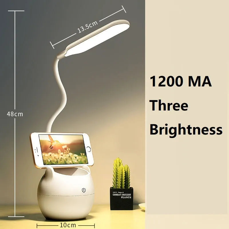 Simple style silver and white rechargeable LED clip desk lamp with adjustable arm, attached to a desk edge next to a book.