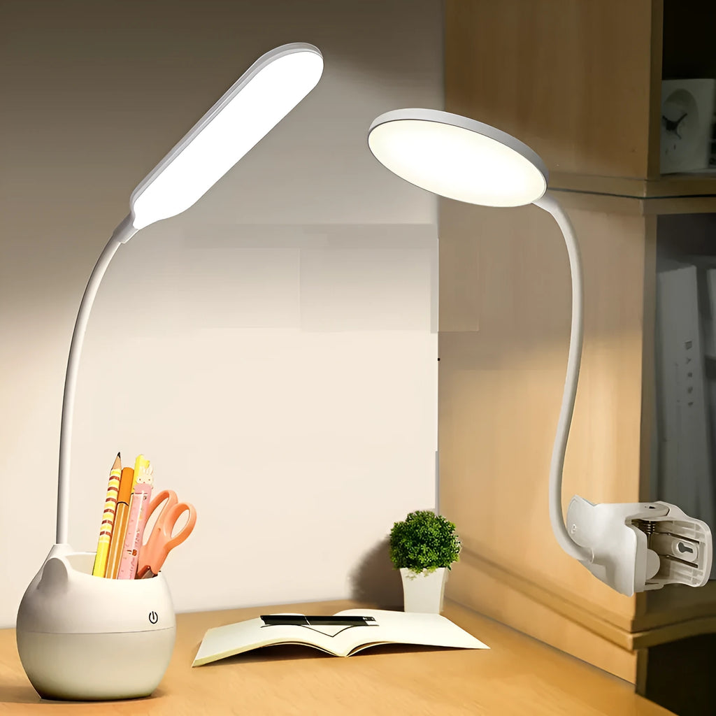 Simple style silver and white rechargeable LED clip desk lamp with adjustable arm, attached to a desk edge next to a book.