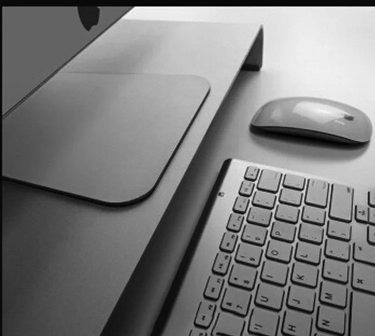Silver aluminium alloy monitor riser with dimensions 50x22x6cm on a desk