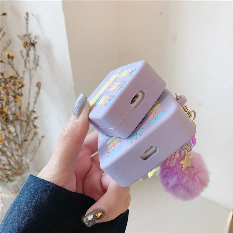 Purple silicone clamshell case for Apple AirPods Pro and AirPods 1 2 with a white fur ball pendant.