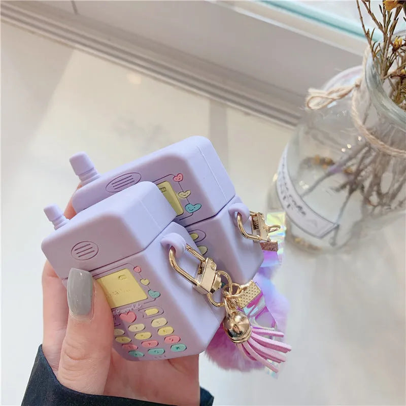 Purple silicone clamshell case for Apple AirPods Pro and AirPods 1 2 with a white fur ball pendant.