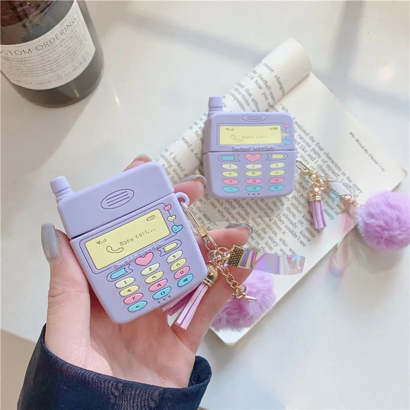 Purple silicone clamshell case for Apple AirPods Pro and AirPods 1 2 with a white fur ball pendant.
