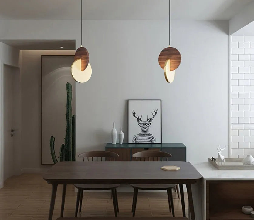 Long-line modern chandelier made from carved solid walnut wood, mounted on a wall.