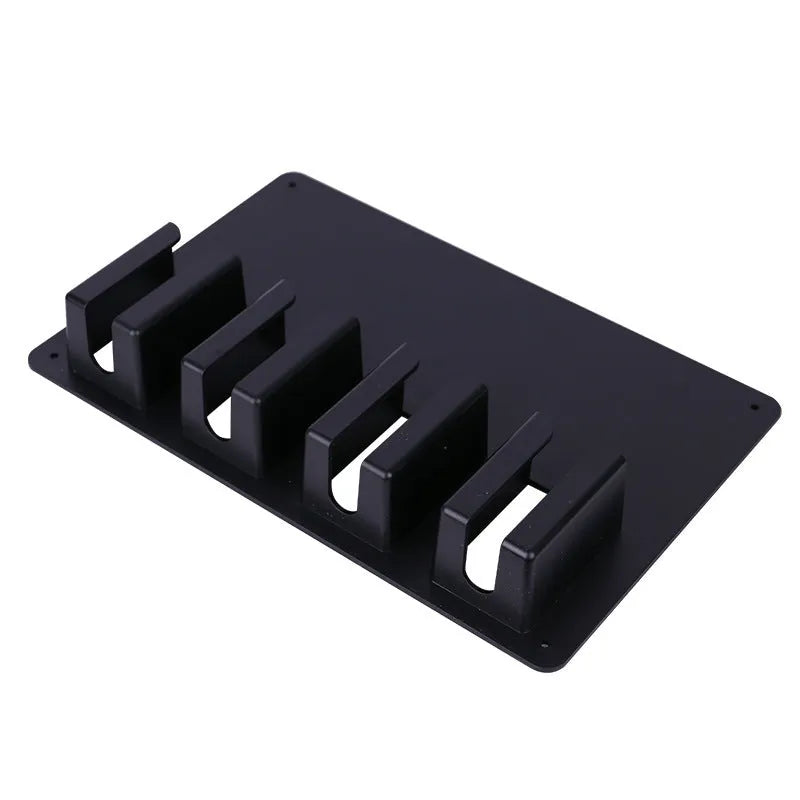 Black plastic wall-mounted frame holding four hair clippers for salon or home storage.
