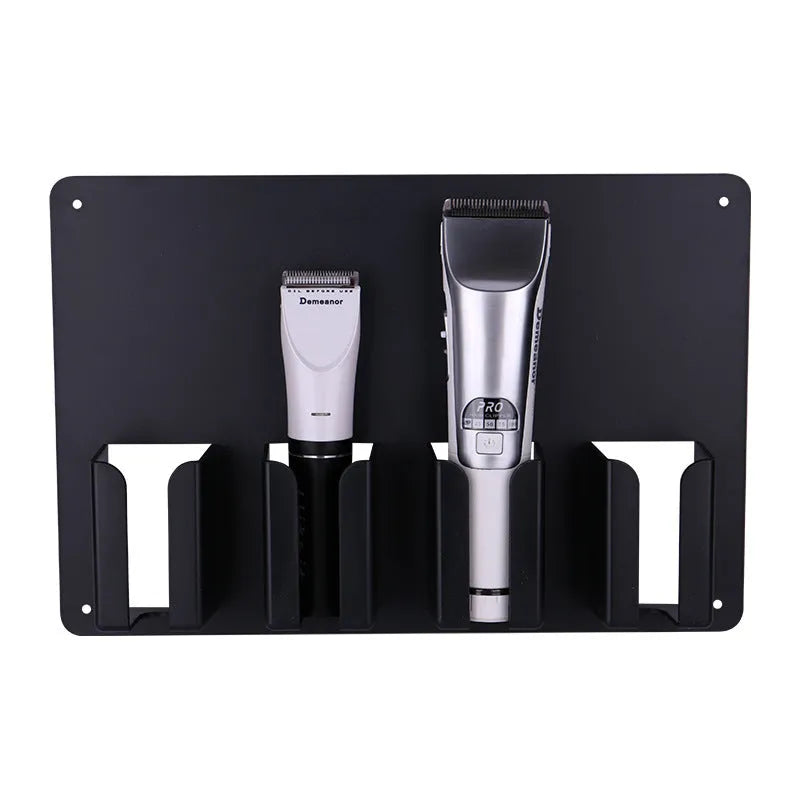 Black plastic wall-mounted frame holding four hair clippers for salon or home storage.