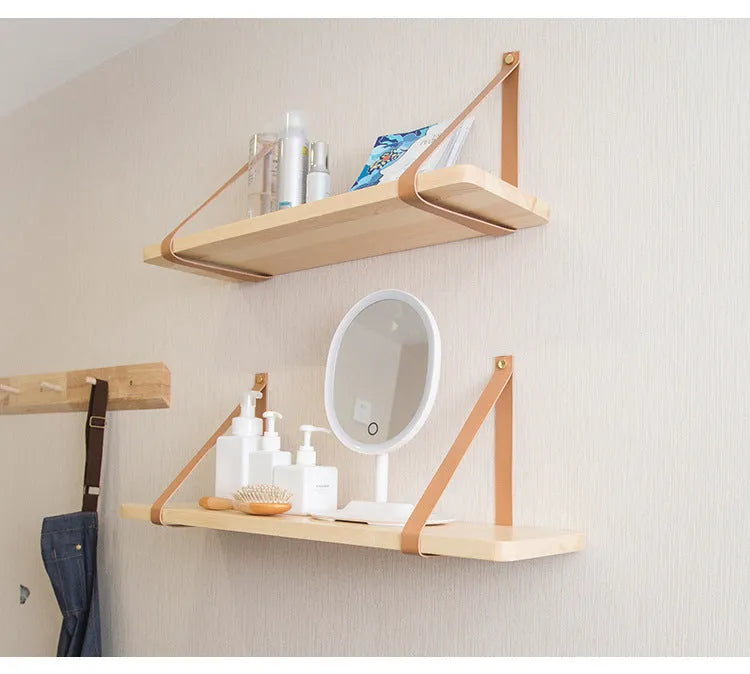 Pine wood wall-mounted storage shelf in Nordic style, 50cm wide by 16cm deep, holding books and remote controls.