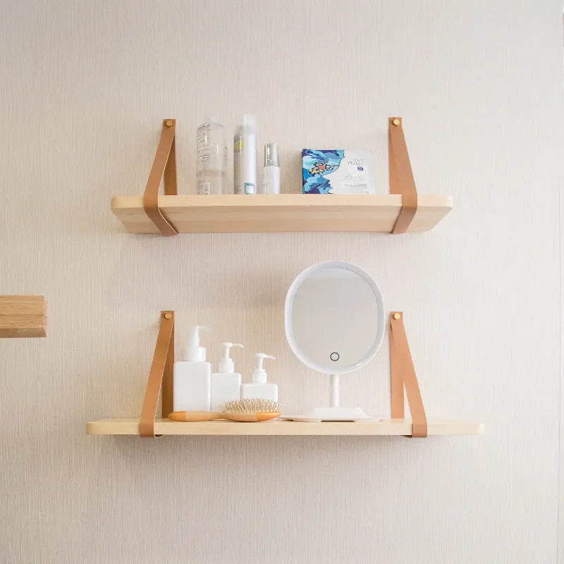 Pine wood wall-mounted storage shelf in Nordic style, 50cm wide by 16cm deep, holding books and remote controls.