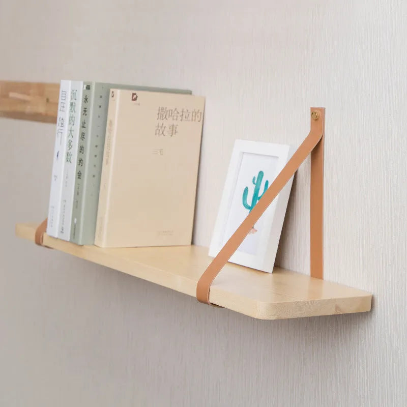 Pine wood wall-mounted storage shelf in Nordic style, 50cm wide by 16cm deep, holding books and remote controls.