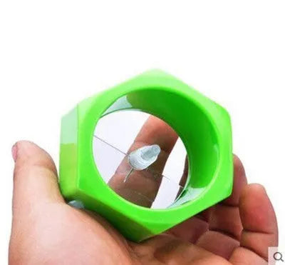 Yellow and green plastic vegetable cutter for spiral slicing cucumbers