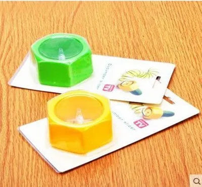 Yellow and green plastic vegetable cutter for spiral slicing cucumbers