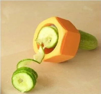 Yellow and green plastic vegetable cutter for spiral slicing cucumbers