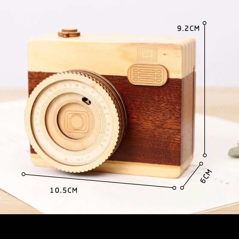 Wooden rotating music box with camera design in miniature carton packaging, pine wood construction