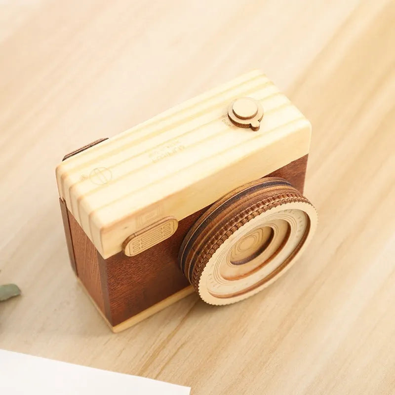 Wooden rotating music box with camera design in miniature carton packaging, pine wood construction