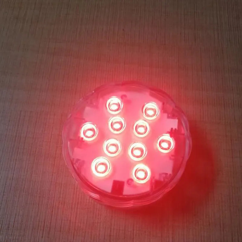 White waterproof disc LED light with remote control for swimming pools and garden decoration.