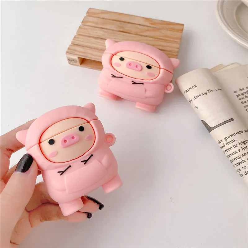 Pink silicone AirPods case cover with cartoon pig design and a metal hook attached