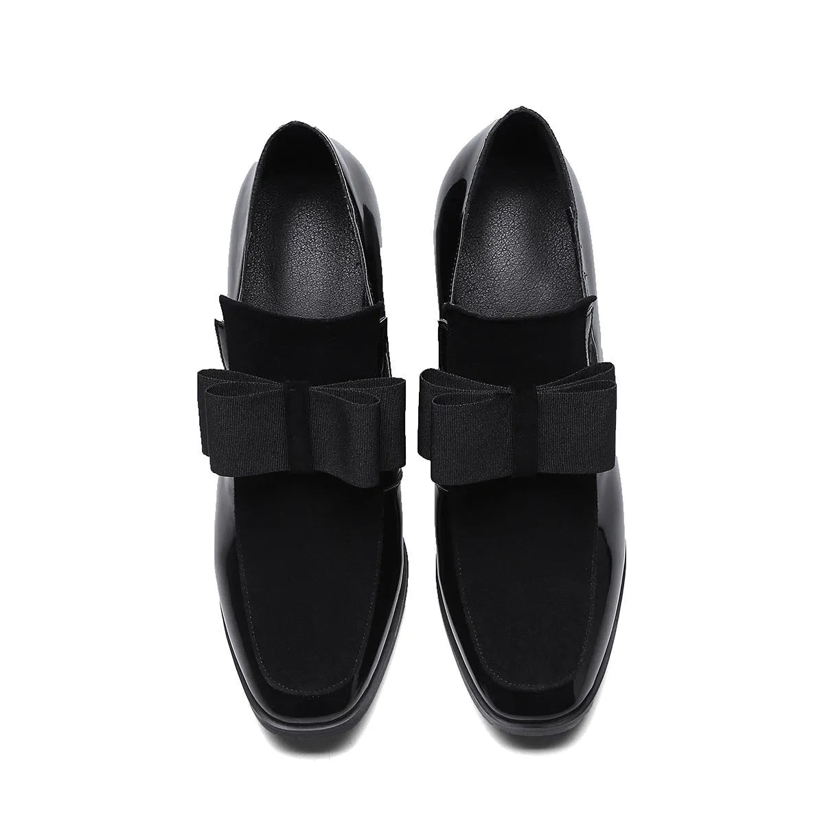 Black patent leather high heels with a thick block heel and square toe on a white background.