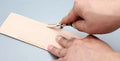Sectional cutting wide shovel edge thinning hand tool for leatherworking.