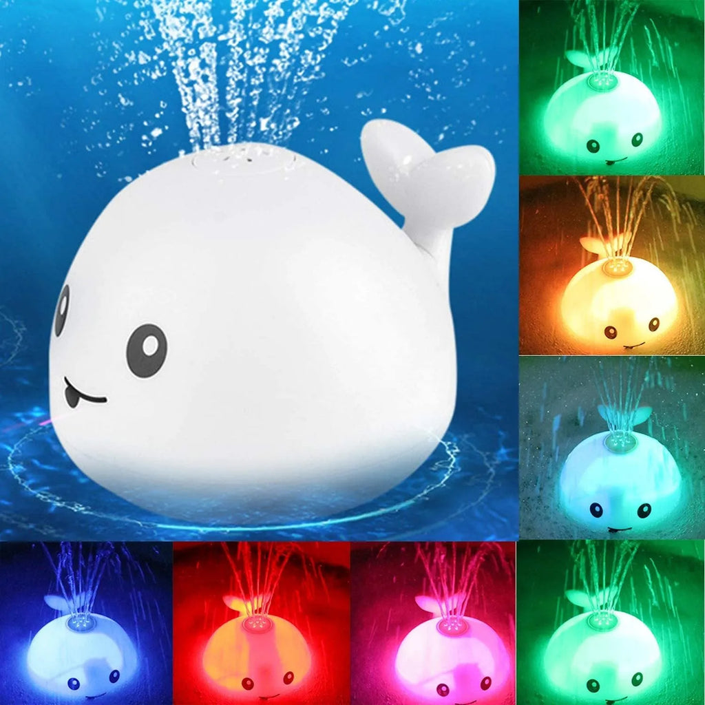 White and blue whale-shaped electric bath toy spraying water with coloured lights flashing