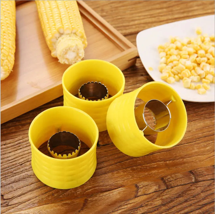Yellow manual corn grinder thresher with corn-shaped PP handle and stainless steel shelling gear.