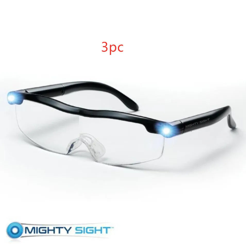Transparent black USB LED reading glasses with illuminated frame on a desk