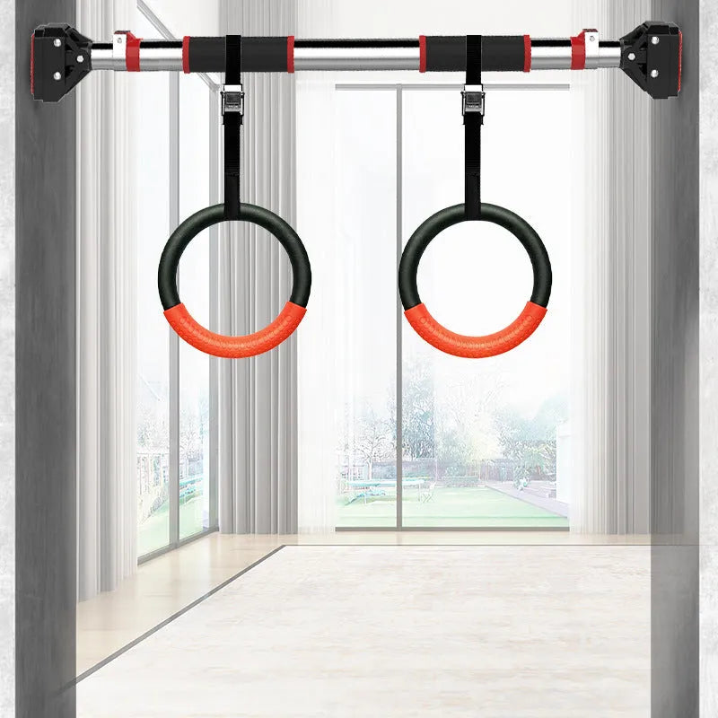 Black rubber encapsulated gymnastics training rings with ropes and gloves on indoor floor