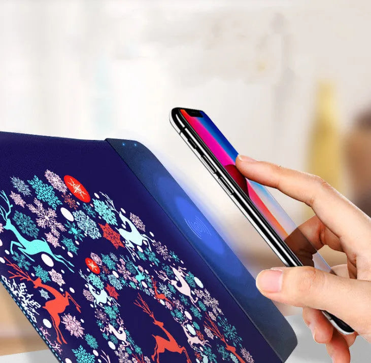 Wireless charging mouse pad with cartoon design and RGB lighting, showing cloth surface and rubber base