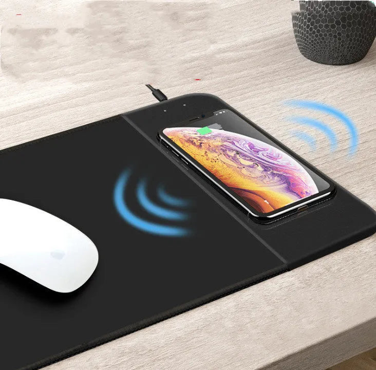 Wireless charging mouse pad with cartoon design and RGB lighting, showing cloth surface and rubber base