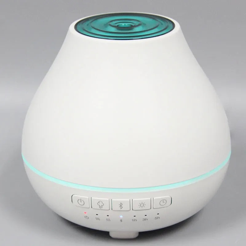 White round Bluetooth aromatherapy humidifier diffuser with LED night light on a wooden surface