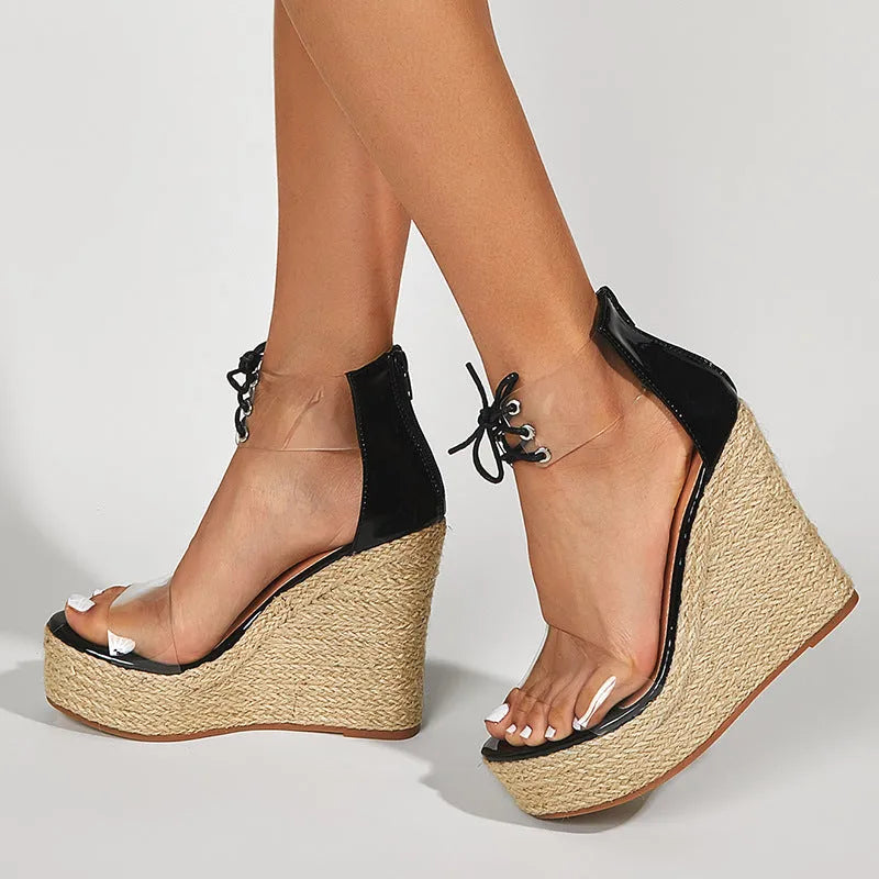 Black women's wedge sandals with hemp rope detail on a super high platform heel and front tie closure.