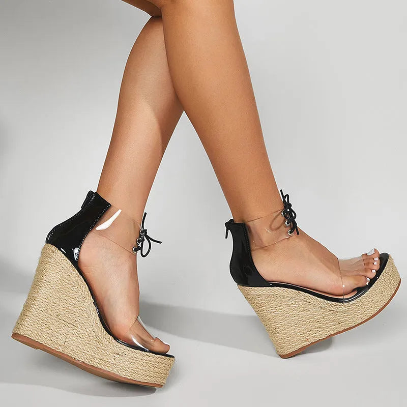 Black women's wedge sandals with hemp rope detail on a super high platform heel and front tie closure.