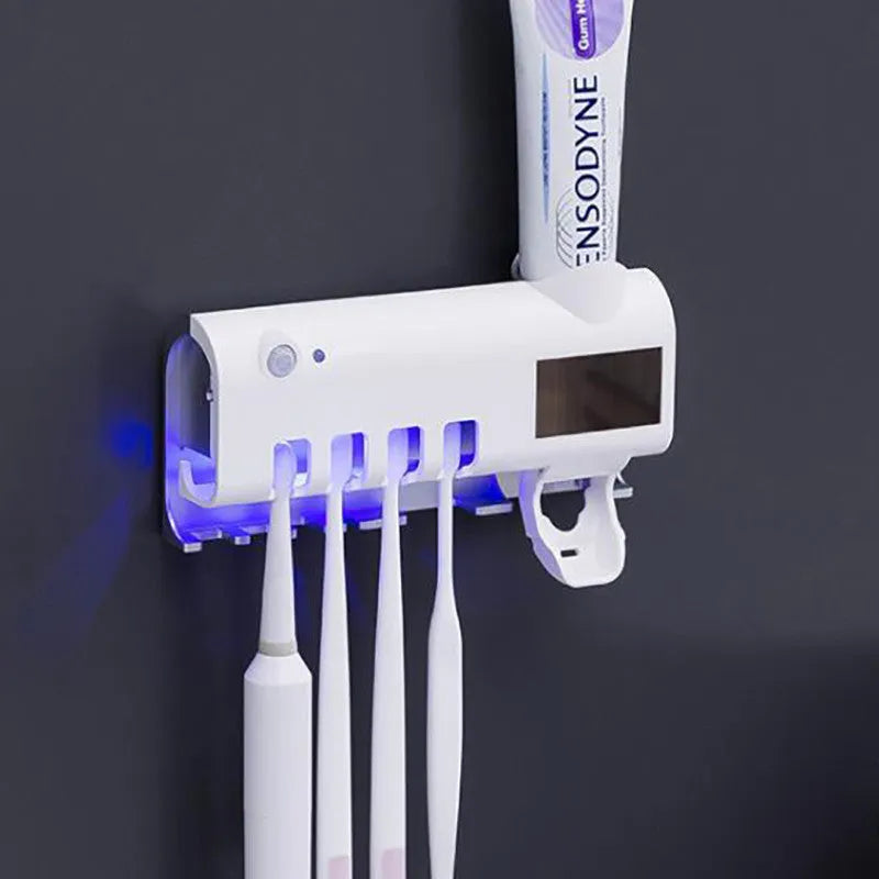 Black smart UV toothbrush steriliser with automatic toothpaste squeezer mounted on a bathroom wall