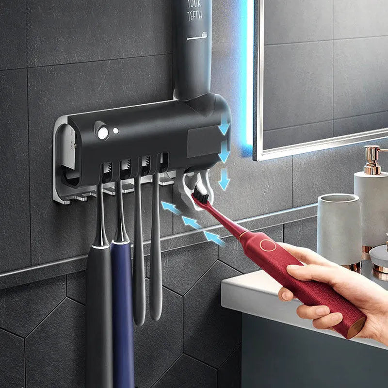 Black smart UV toothbrush steriliser with automatic toothpaste squeezer mounted on a bathroom wall