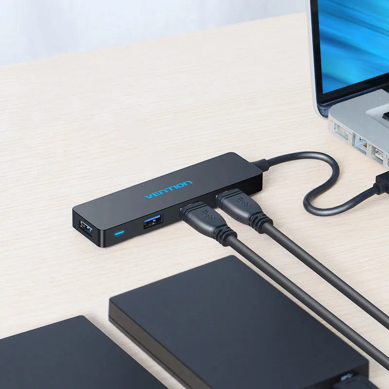 Black USB 3.0 four-port hub with a short cable and nickel-plated connectors