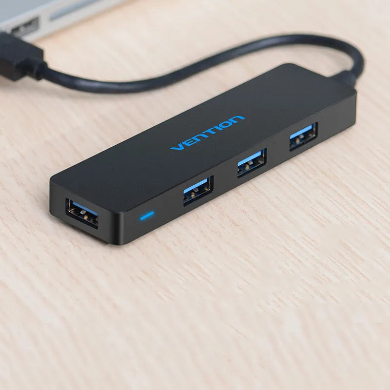 Black USB 3.0 four-port hub with a short cable and nickel-plated connectors