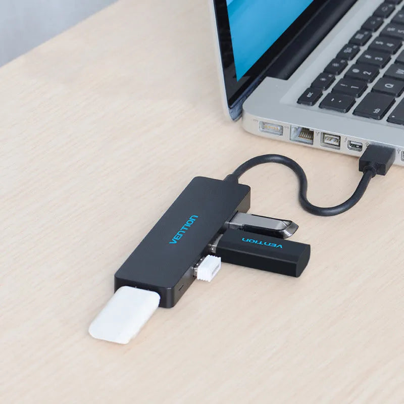 Black USB 3.0 four-port hub with a short cable and nickel-plated connectors