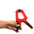Tool steel woodworking clamp in double colour finish, 6 inch size, on wooden workbench