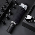 Black automatic reverse folding umbrella with plastic non-slip handle, shown open.