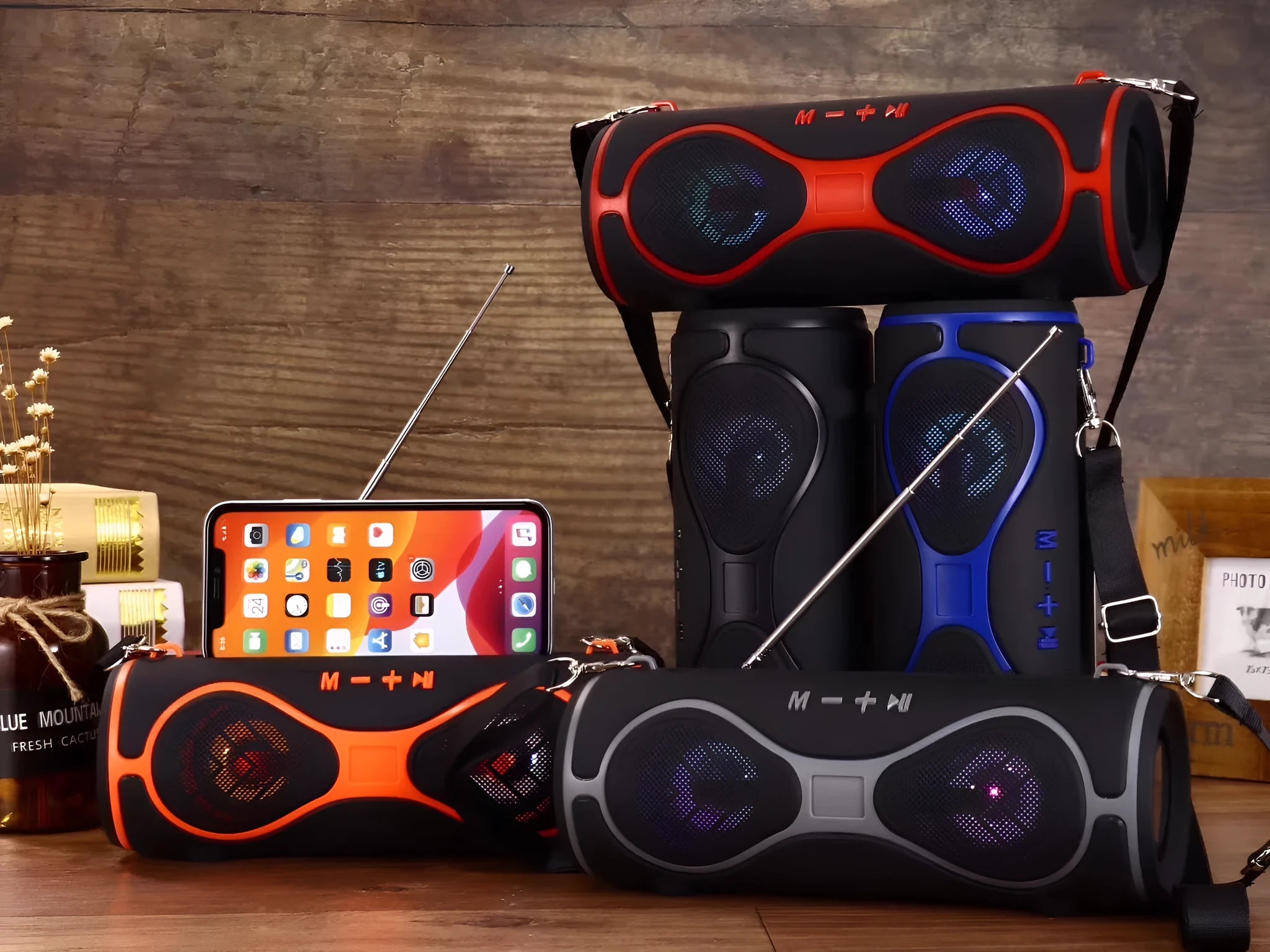 Lantern-shaped portable Bluetooth speaker with shoulder strap and built-in mobile phone stand in black colour.