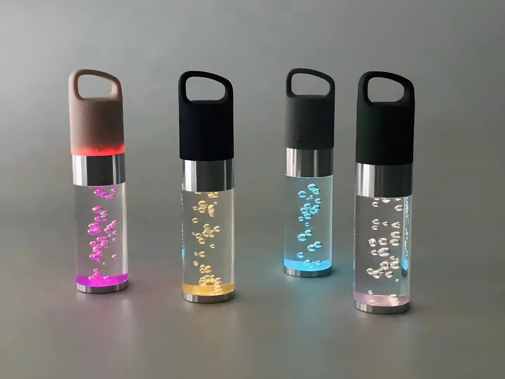 Portable Bluetooth speaker with colourful LED lights in pink, black, silver grey, and green colour options