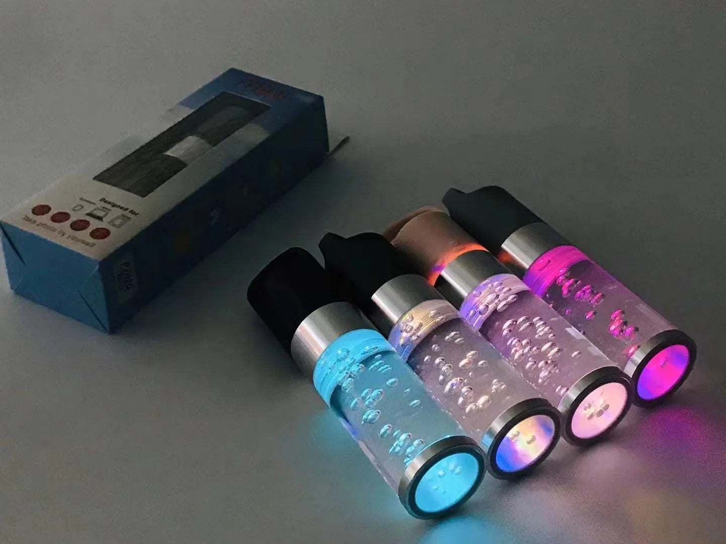 Portable Bluetooth speaker with colourful LED lights in pink, black, silver grey, and green colour options