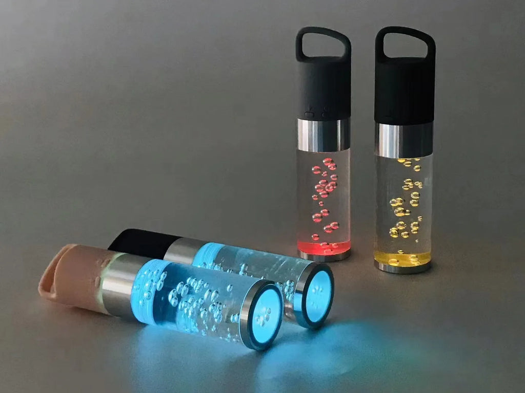 Portable Bluetooth speaker with colourful LED lights in pink, black, silver grey, and green colour options