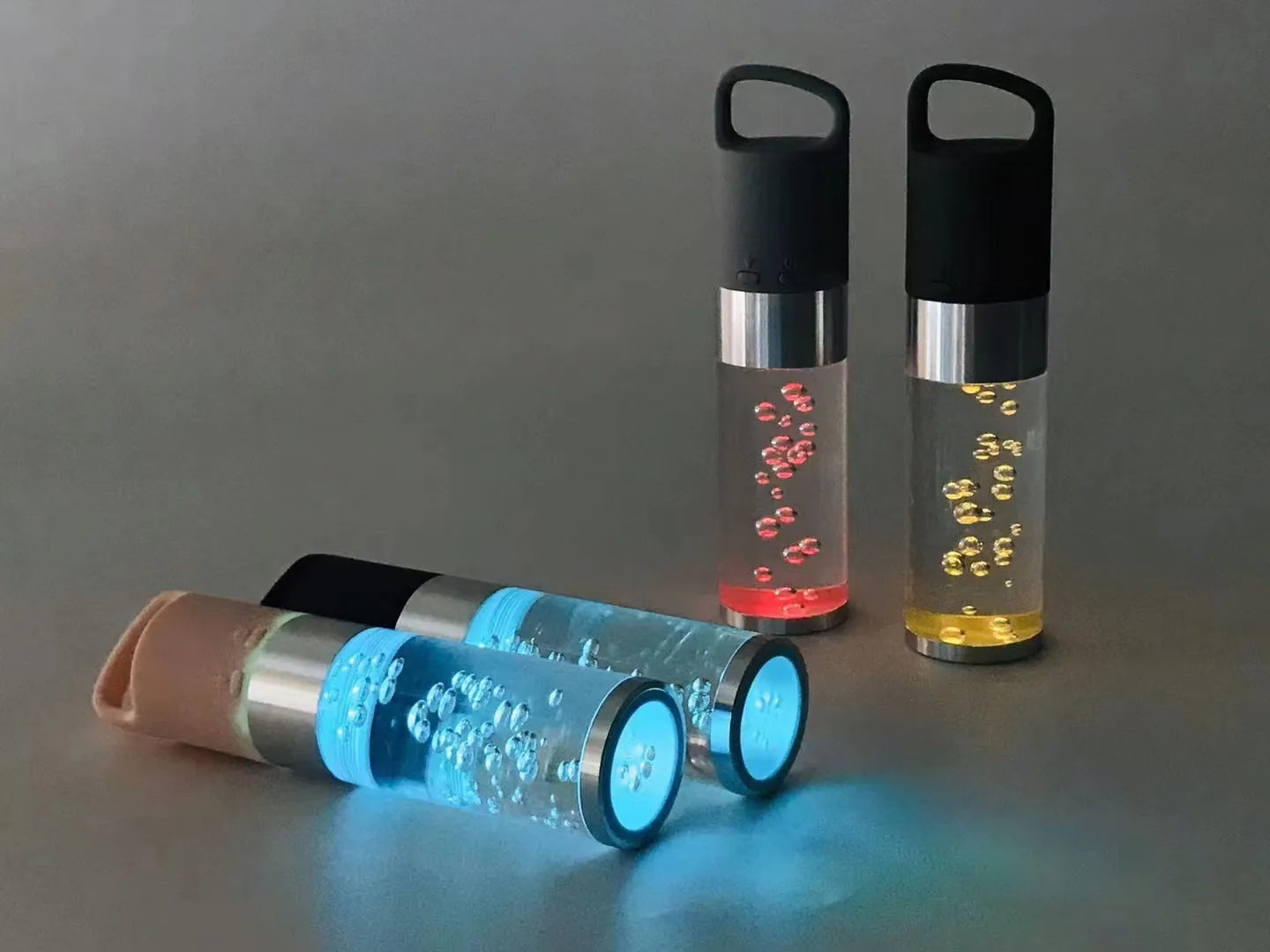 Portable Bluetooth speaker with colourful LED lights in pink, black, silver grey, and green colour options