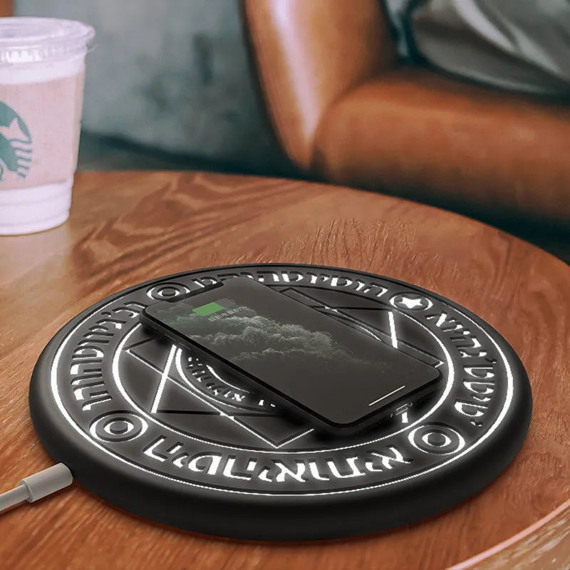 Square wireless phone charger with magic array pattern design glowing blue during charging