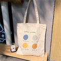 Women's medium canvas tote bag with geometric pattern, zipper closure, and shoulder straps in orange or light pink colour