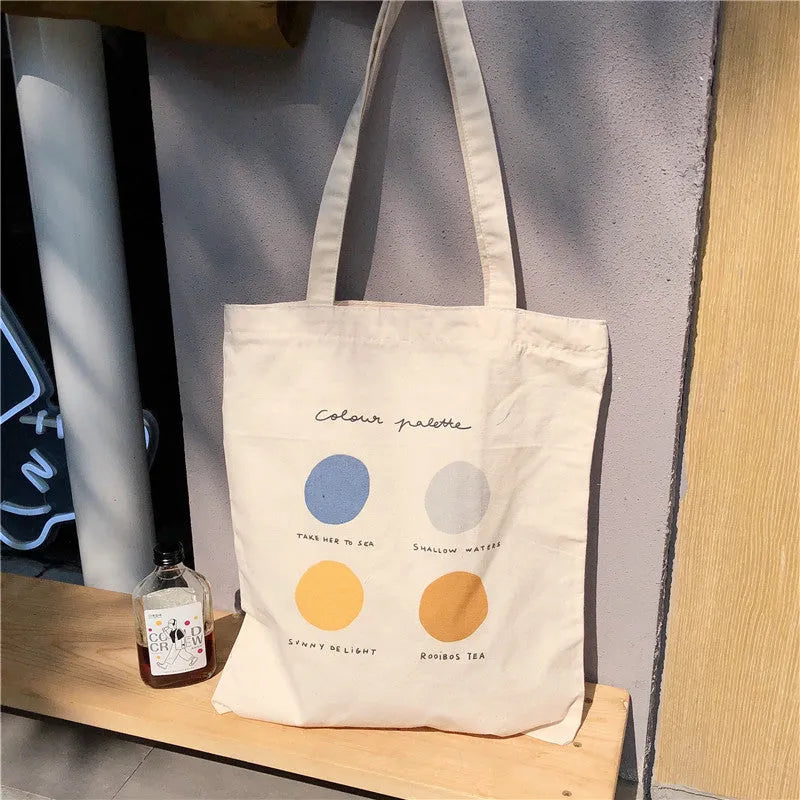 Women's medium canvas tote bag with geometric pattern, zipper closure, and shoulder straps in orange or light pink colour